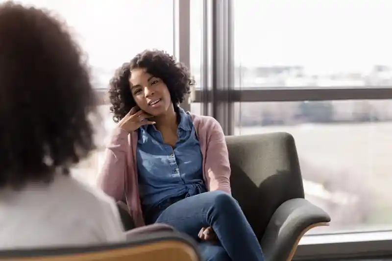 Woman using phone sign instructing friend to call PLC